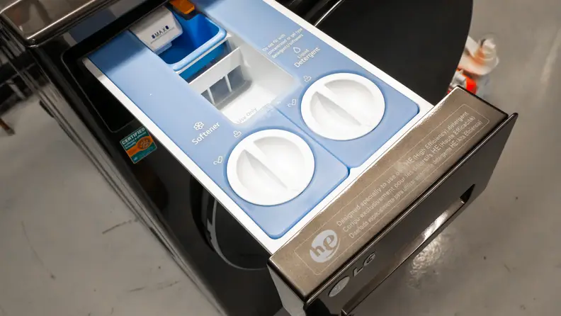 A close-up of the LG WM6998HBA’s opened dispenser, with space for both softener and liquid detergent.