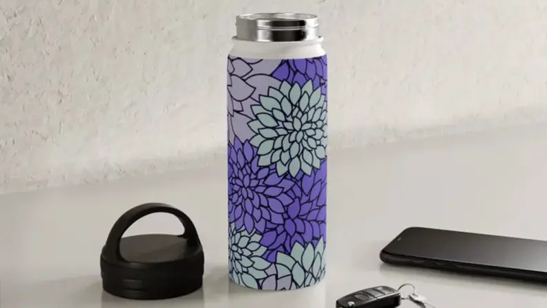 A purple water bottle on a kitchen counter.