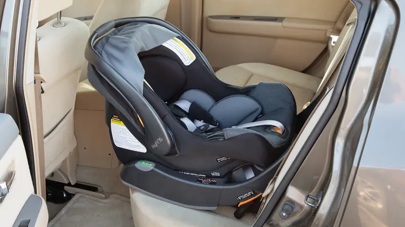 A Chicco KeyFit35 installed in the backseat of a car.