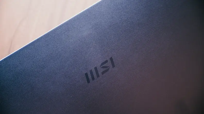 A close up shot of the top of the laptop with the MSI logo