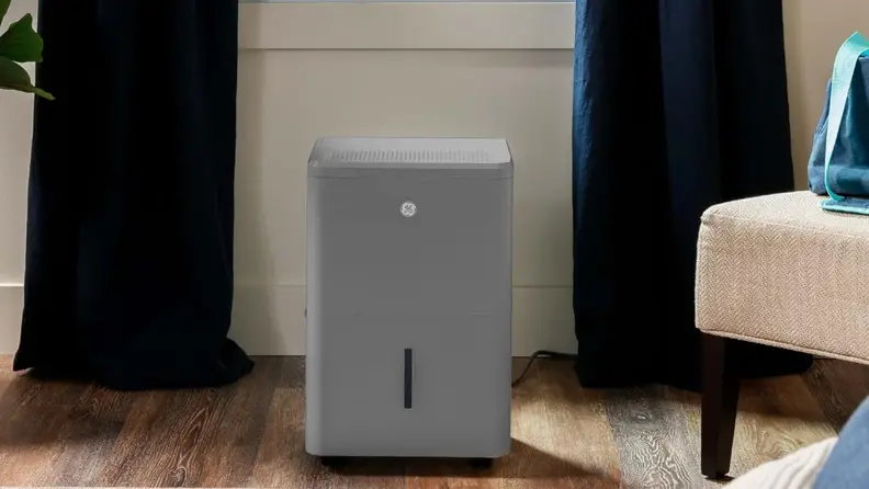 A grey ge dehumidifier sits on a floor