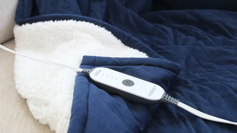 The Sunbeam Sherpa control unit lying on top of the blue blanket