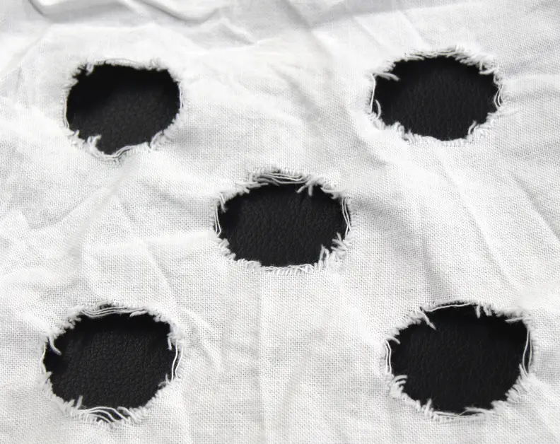 This is an example of a used mechanical action strip. The frayed strains with the circles are tallied up to determine the amount of clothes wear.