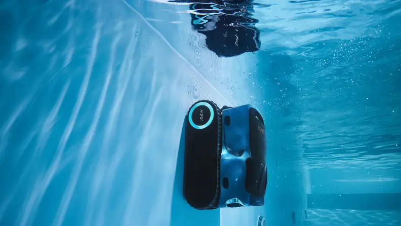 A robot pool cleaner underwater climbing the pool wall