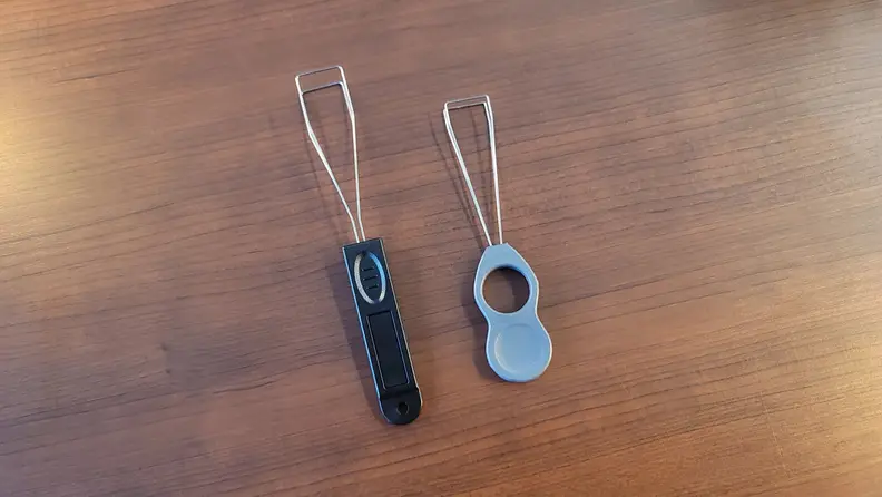 Two wired keycap pullers next to one another