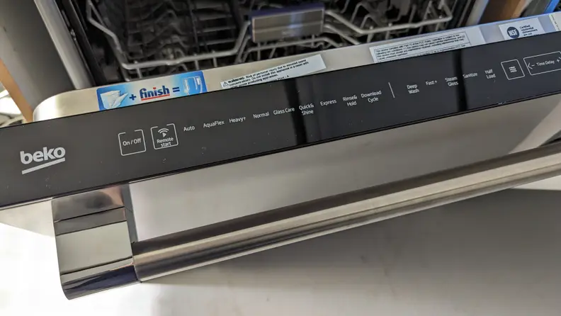 The control panel of a Beko dishwasher showing a rinse and hold cycle to keep dishes moist before washing