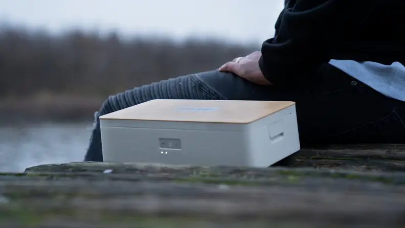 Steambox product on a doc, mid-heating process, with person sitting beside it