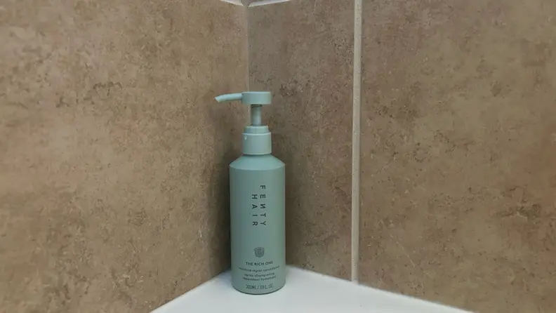 Photo of the Fenty Hair Rich One Moisture Repair Conditioner in a shower.