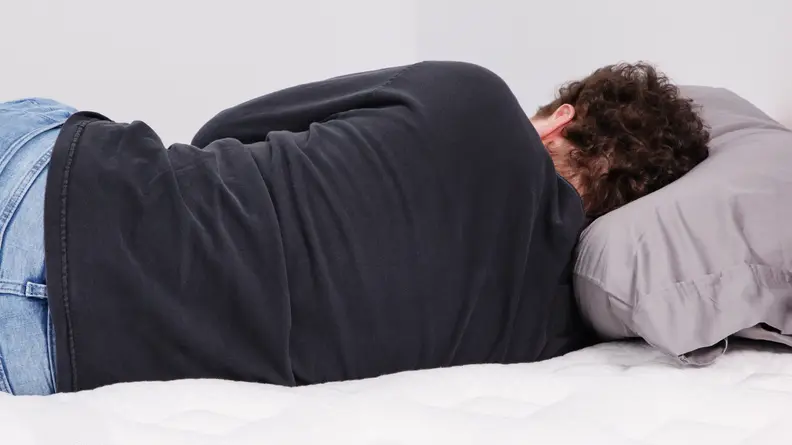 A person lying on their side on the Leesa Sapira Chill.