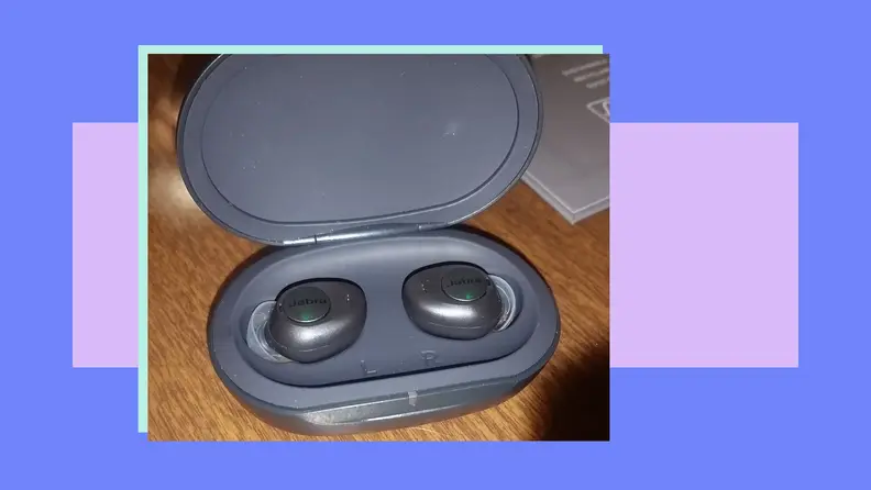 Black pair of Jabra Enhance Buds in charging case.