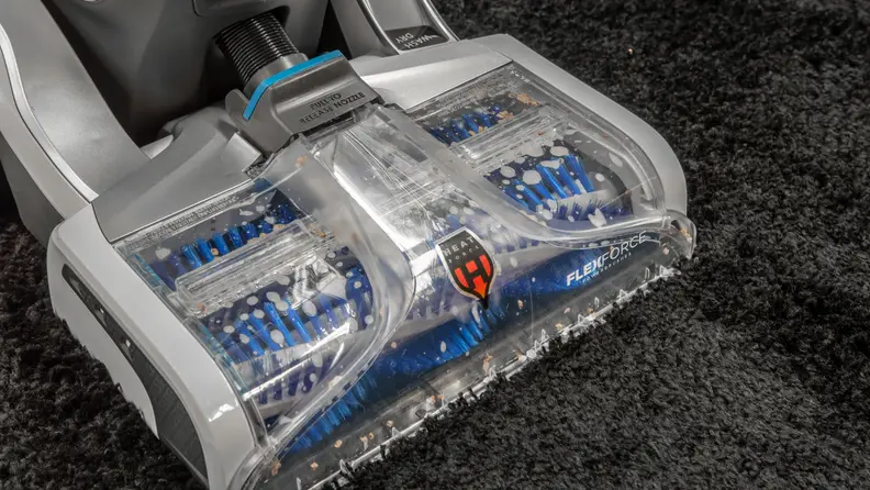 Carpet cleaner cleaning shag throw rug.