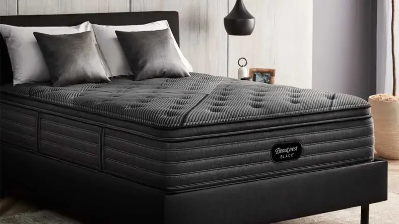 Beautyrest Black mattress to the side in a bedroom setup.