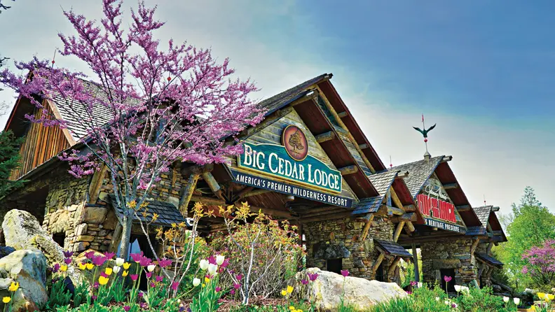 A lodge stands among flowering trees