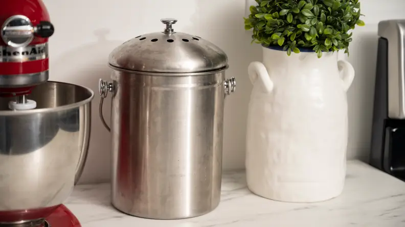 Epica stainless steel compost bin sitting on kitchen counter.