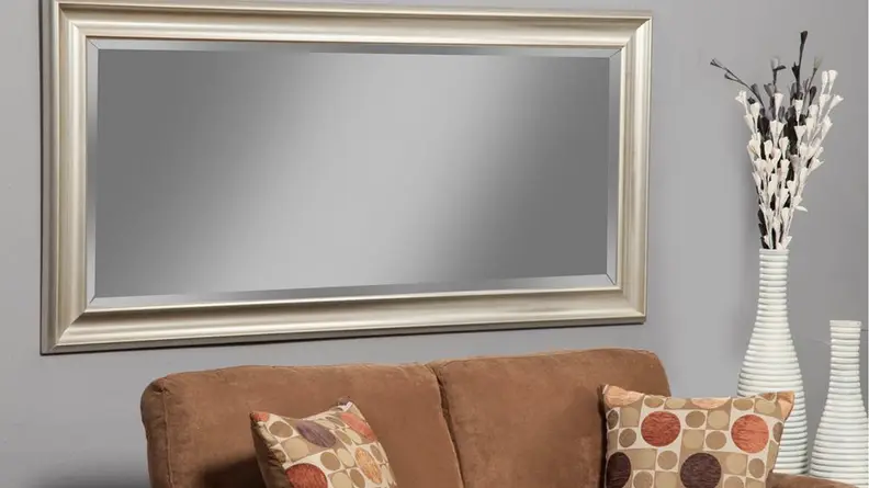 A full length mirror over a couch