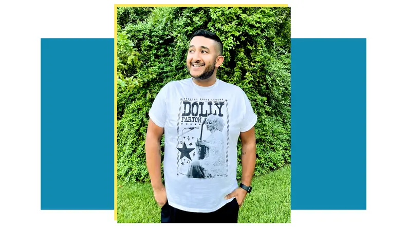 Person wearing a white Dolly Parton graphic t-shirt.