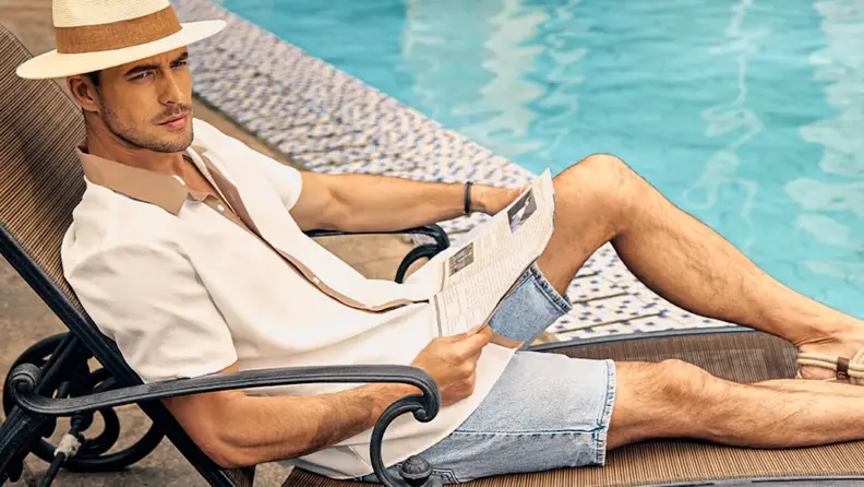 Man lounging by a pool.