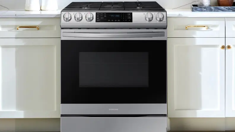 Samsung oven range next to white cabinets in modern kitchen.