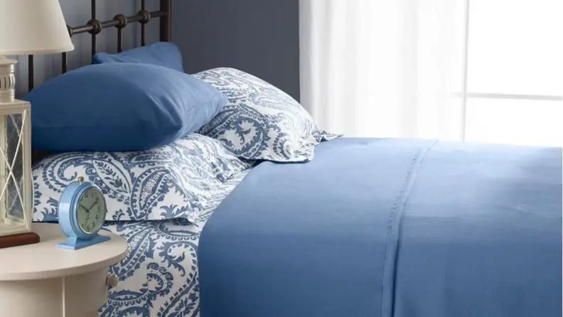 blue and white patterned flannel supima sheets on a bed