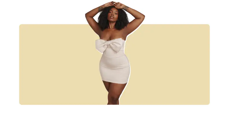 A white mini dress with a crystal-embellished bow along the bodice.