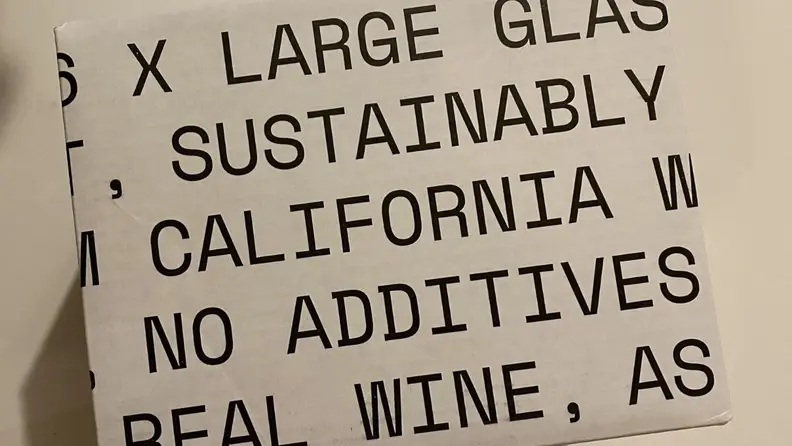 Usual Wines packaging, which features largely printed words about the product.