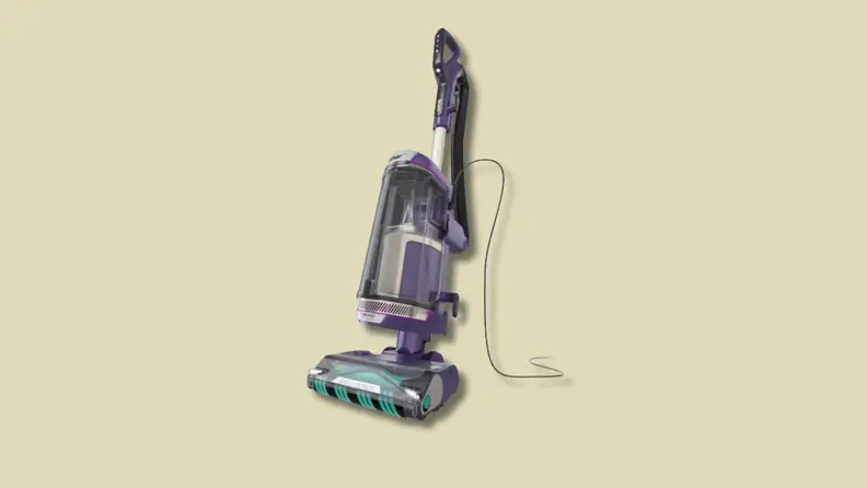 An upright vacuum cleaner on a beige background