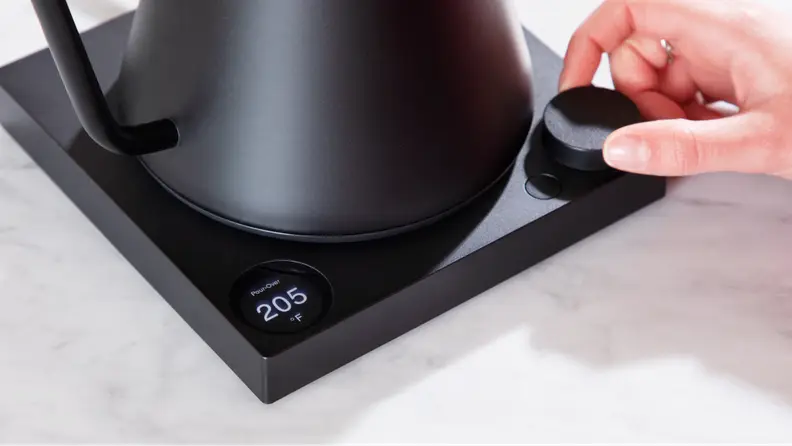A hand twisting a dial in the Fellow Stagg EKG Pro.