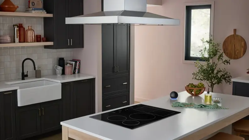 A zoomed out shot of a kitchen counter with the KitchenAid induction cooktop in an island.