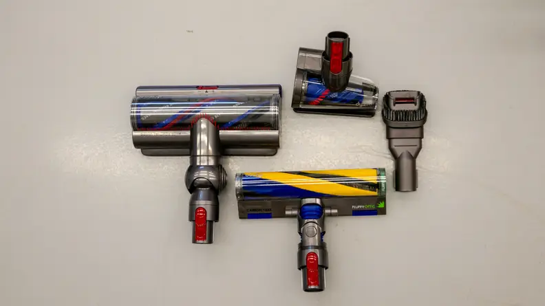 The attachments for the Dyson Gen5detect laid on out the floor including the Fluffy Optic, Digital Motarbar, Hair Screw, and Combination tool.