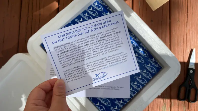 In the center of the image, a note suggests there's dry ice involved in the packaging and users should use caution.