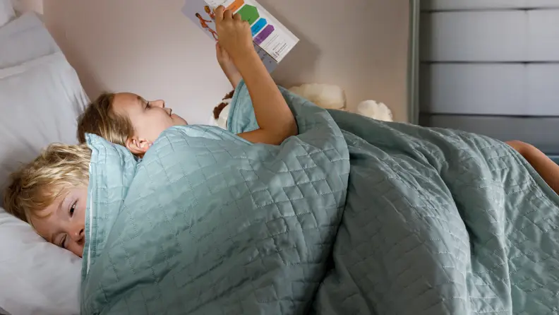 Cuddle up with a book under a cozy blanket.