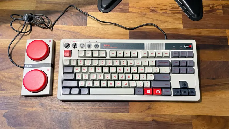 A grey retro keyboard with two large red buttons, the best budget gaming keyboard on the market