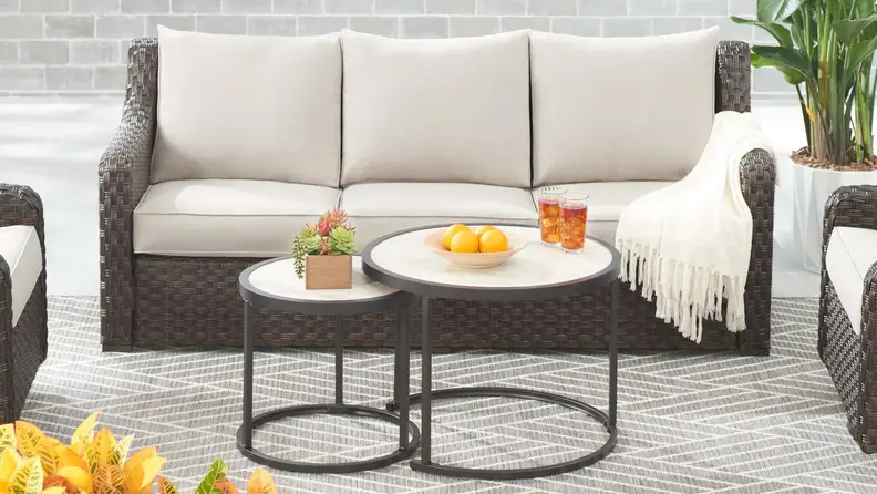 beige and brown outdoor couch and matching table outdoors