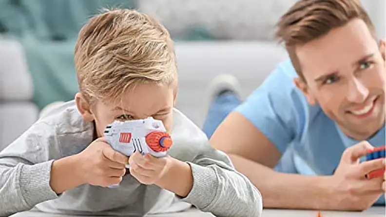 Two children aim toy laser guns.