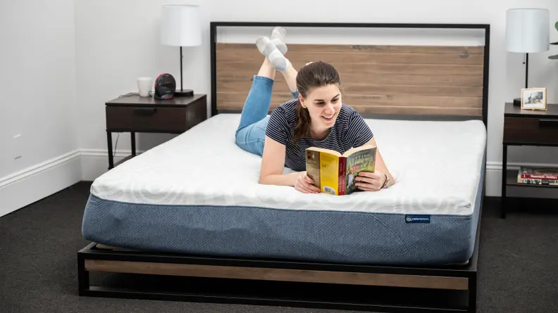 woman reading on stomach on serta