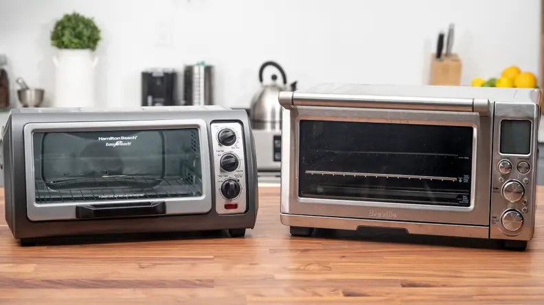 Toaster ovens sitting on a table.