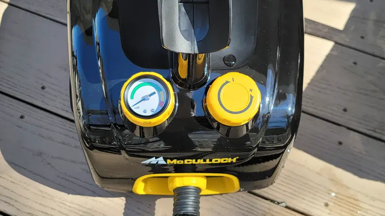 A steam gauge on a black steam cleaner with a needle pointing at the green zone.