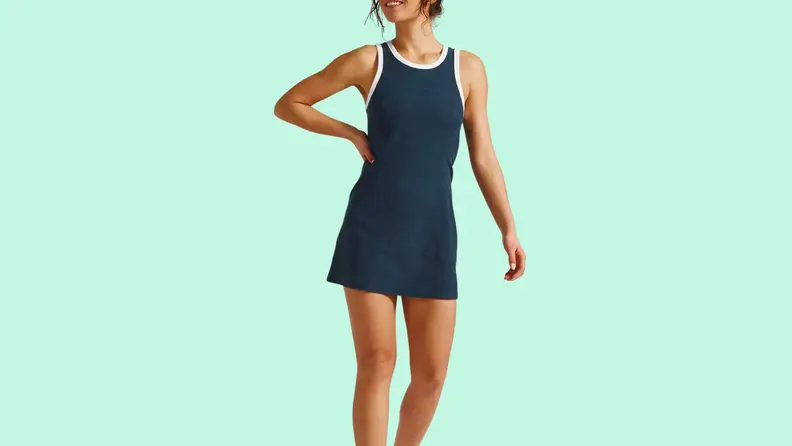 Woman in black exercise dress with white piping.