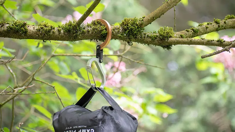 clip holding bag attached to a tree limb