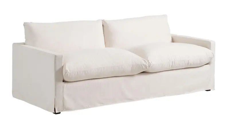 A white fluffy couch on a white background.