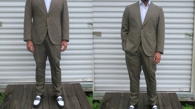 Man standing in front of storage shed wearing green cotton suit from Suitsupply.