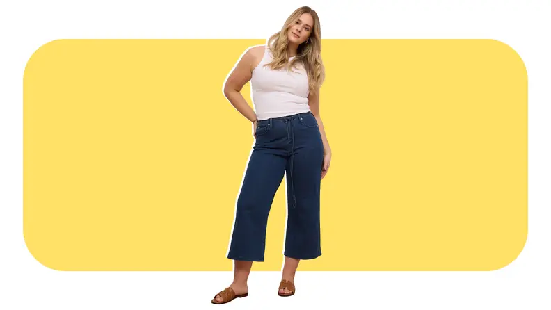 Model wearing white tank top and capri denim jeans from Yoga Jeans