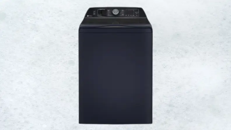 A dark blue washing machine sits on a white sudsy background