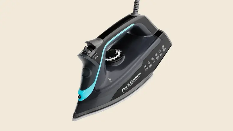 A PurSteam iron on a beige background
