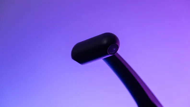 Black Govee camera shown in front of a purple-lit wall.