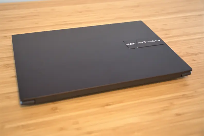 A closed laptop sits on top of a desk