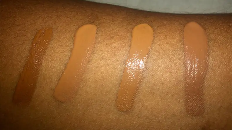 A panelist wears swatches of concealer on her arm.