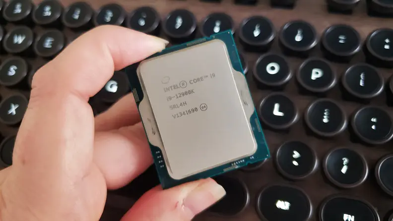 A hand holding a desktop computer processor