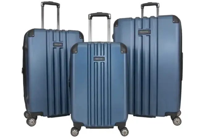 Three Kenneth Cole suitcases on a white background.