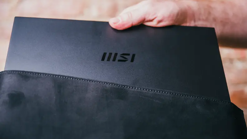 The laptop is tucked into a soft case